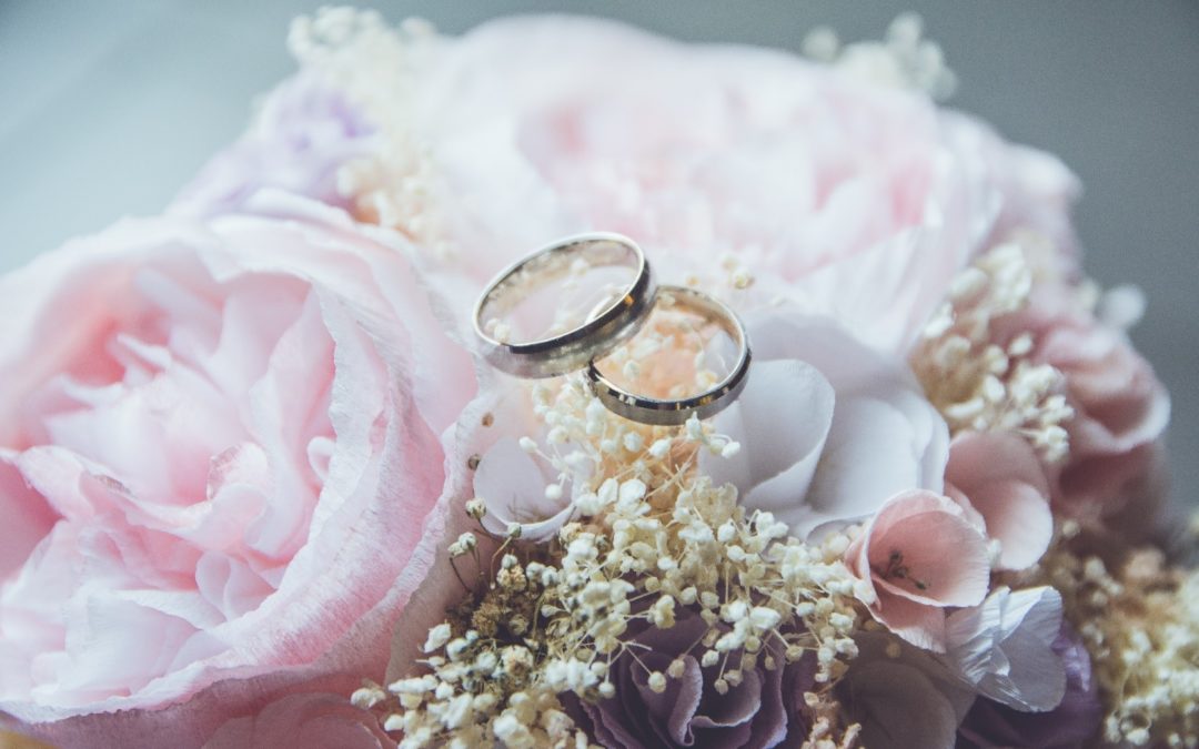 Two rings side by side on a pink bouquet